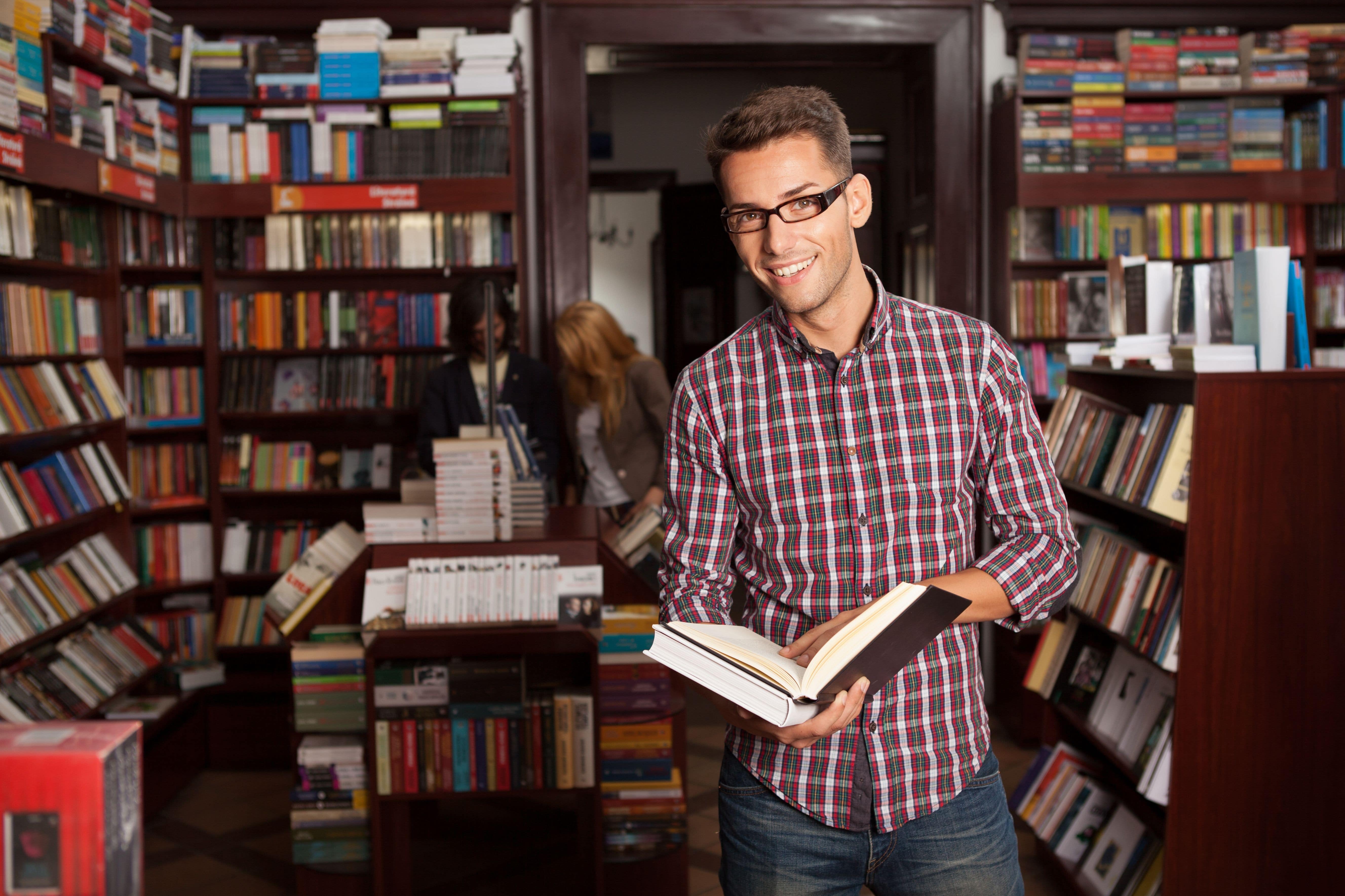 Man Holding a Book in the Library